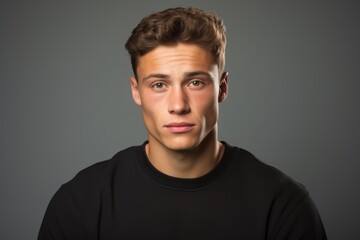 Portrait of a young man over grey background. Looking at camera.