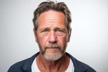 Portrait of a senior man with wrinkles on his face. Gray background.