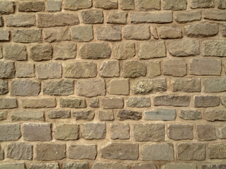 Old weathered stone wall. Historical texture of old wall.