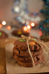 Cookies folded in a column and tied with a rope on paper and a wooden table. Bright and colorful...