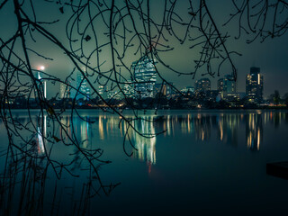 Vienna skyline reflecting on old Danube at night 