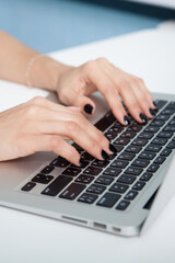Closeup portrait of woman&#39;s hand typing on computer keyboard