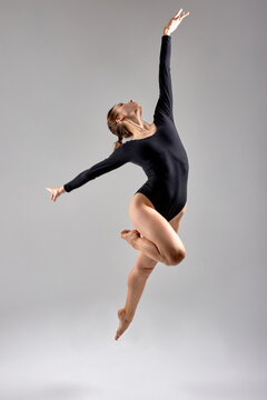 skilled ambitious dancer jumping in studio.full length photo. dancer stretching up for vicory, success, full length white isolated background, dream, free time, lifestyle, hobby, acheivment