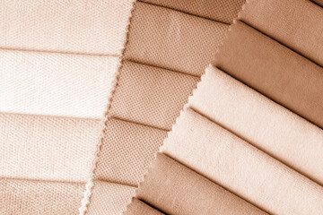 a variety of fabrics with a color palette. New trending PANTONE Peach Fuzz color of 2024 year