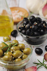 Black and green olives in glass bowls