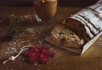 Christmas stollen with coffee cup and decoration toys. Sweet Christmas bread with cacao and...