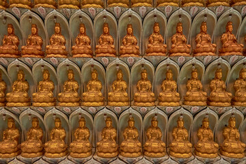 wall of miniature buddha statues horizontal