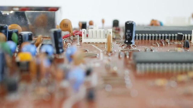 Close-Up Blurred Macro Shot Of Electronic Circuit Board With Microchips. Computer Main Board, Electronic Circuit Assembly.