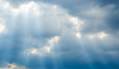 amazing blue cloudscape background with sun beams , clouds and sun rays streaming throught thr cloud