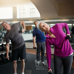 Senior fitness, stretching people with dumbbells at gym for training, wellness or cardio exercise....