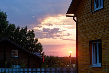 Colorful sunset in the village in summer