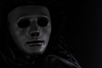 black face mask in fabric, vintage elegance, art on stage, Drama and theatre, black background,...