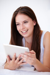 Fototapeta premium Woman, tablet and thinking on bed of online search, social media and streaming service for film choice or movies. Happy young person with ideas or home inspiration on digital technology in bedroom