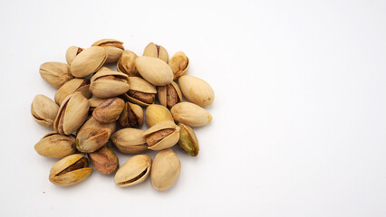 Pistachios on white background.It's roasted dried green nut or shell  close up  top view healthy snack  .