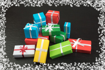 Gift boxes and colorful present for christmas on blackboard. Top view with copy space.
