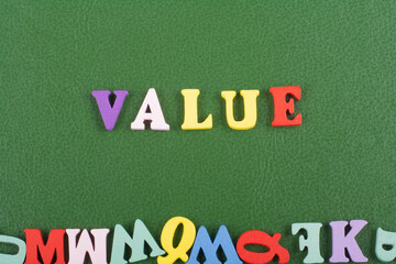 VALUE word on green background composed from colorful abc alphabet block wooden letters, copy space for ad text. Learning english concept.