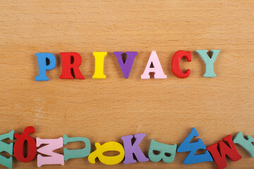 PRIVACY word on wooden background composed from colorful abc alphabet block wooden letters, copy space for ad text. Learning english concept.