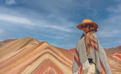 Young girl in front of the Vinicunca Rainbow Mountain, Peru South America - obrazy, fototapety, plakaty