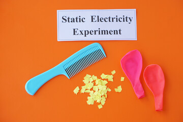 Comb, ballons and small pieces of paper. Equipment, prepared to do experiment about static...