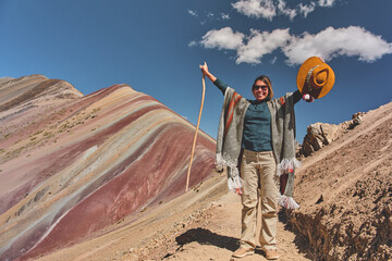 Young girl hiking in front of the Vinicunca Rainbow Mountain, Peru South America