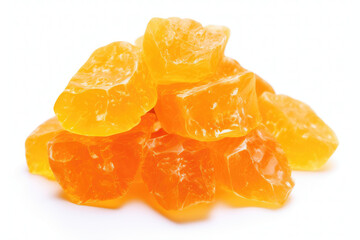 Pile of sugared dried orange chunks, vibrant and translucent, on a white backdrop.