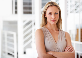 Portrait, serious and a business woman arms crossed in her professional office for company management. Corporate, workplace and a confident a mature CEO, manager or boss with a development mindset