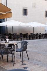 Blurred abstract background of outdoor cafe or restaurant. Outdoor cafe with tables and chairs for the customers that they sit at tables in a terrace area outside cafe