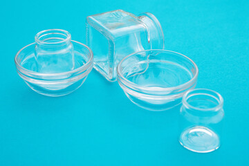 Empty glass bowls and jars for food on the blue background