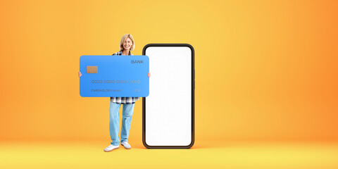 Happy woman with big credit card and blank smartphone screen - obrazy, fototapety, plakaty