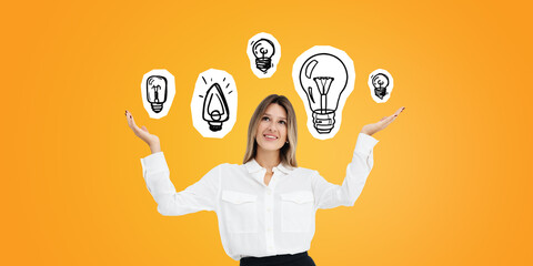 Happy young businesswoman and set of lightbulbs on orange background
