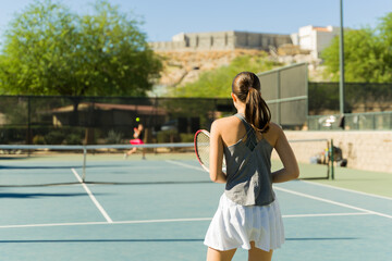 Fototapeta premium Beautiful teenage girl taking tennis lessons