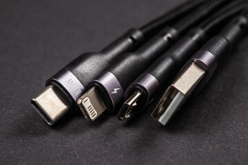 digital computer or smartphone cables. Usb type c, mini-usb, lightning connector. on dark background