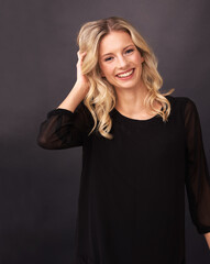 Woman, fashion and smile in portrait, hair and studio by black background. Female model person,...