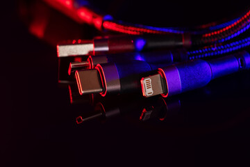 Different USB charging plugs on dark background. USB Type C, Micro USB, Usb lightning - obrazy, fototapety, plakaty