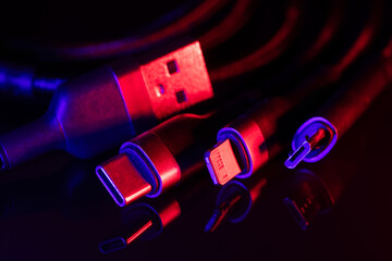 digital computer or smartphone cables. Usb type c, mini-usb, lightning connector. on dark background