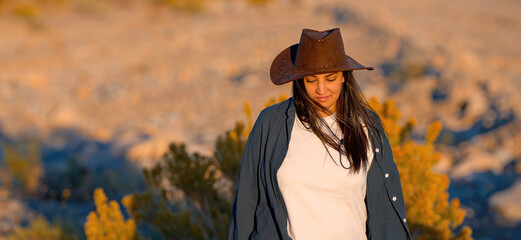 Young cowgirl walking alone through the desert of Nevada - travel photography