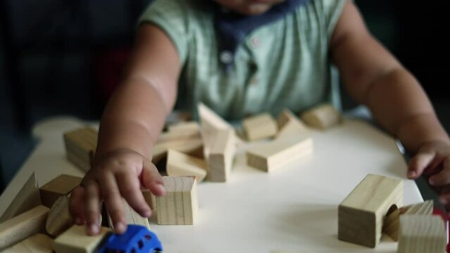 Portrait of boy playing a blocks wood game. selective focus. Copy space. Executive Functions Concept.