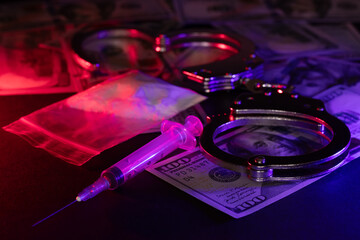 Handcuffs, drug syringe and drug powder and money