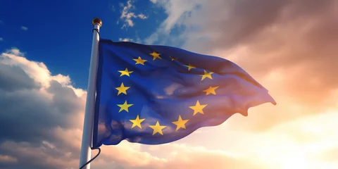 Fototapeten Close up of the Flag of European Union waving in the breeze against a sunset sky. Banner with EU flag. --ar 2:1 --v 5.2 Job ID: 0aaca1ff-e4b8-4255-b0fc-0a35c6de2d46 © atmospherestock