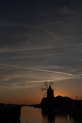 Sunset over a salt mill in Marsala, Sicily