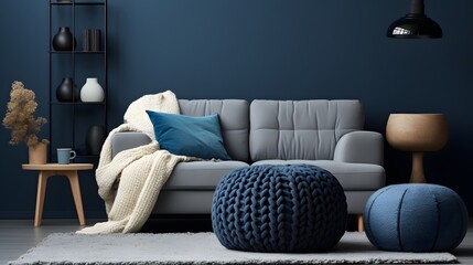 Two knitted poufs near dark blue corner sofa. Scandinavian home interior design of modern living room. - obrazy, fototapety, plakaty