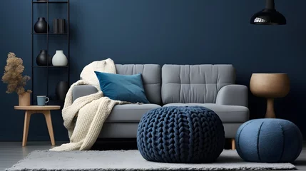 Foto op Canvas Two knitted poufs near dark blue corner sofa. Scandinavian home interior design of modern living room. © Ziyan