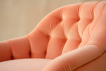 The upholstered armchair is a close-up in delicate shades of peach fuzz, the color of the year 2024. - obrazy, fototapety, plakaty