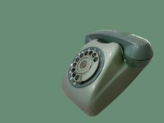 Old-fashioned telephone on a green background