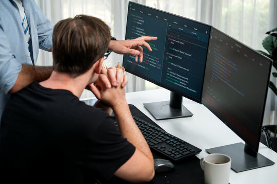 IT developers discussing online software development information on pc screen, creating program coding for latest version application on website. Concept of brainstorming firmware updated. Sellable.