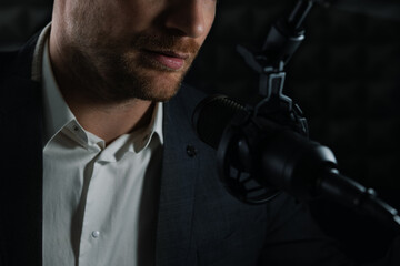 business podcast or radio interview recording. closeup of businessman talking in microphone in...