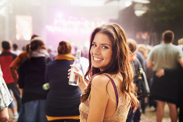 Happy woman, portrait and drink at outdoor music festival with crowd for party, event or DJ in...