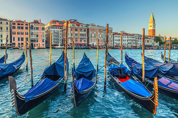 Gondolas moored in water of Grand Canal waterway in Venice - obrazy, fototapety, plakaty