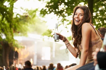 Foto op Aluminium Happy woman, portrait or laughing with drink at music festival, event or outdoor party in nature. Female person smile with alcohol enjoying sound or DJ performance at concert, carnival or summer fest © Jeff Bergen/peopleimages.com