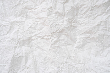 Wrinkled or crumpled white stencil paper or tissue after use in toilet or restroom with large copy space used for background texture in decorative art work